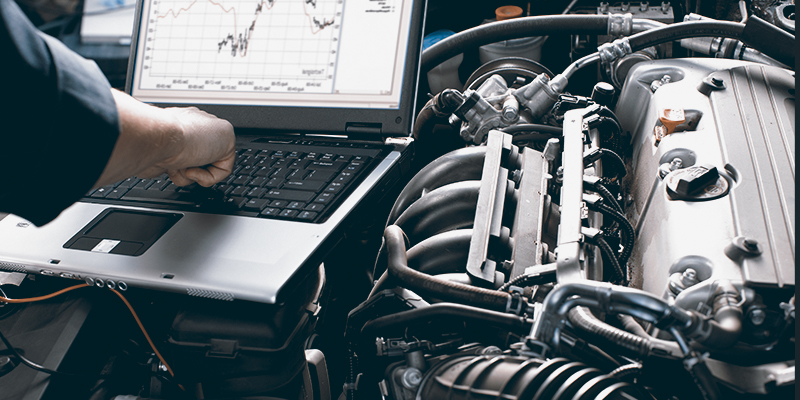 Mechanic looking at a computer - Vehicle Remapping Torquay